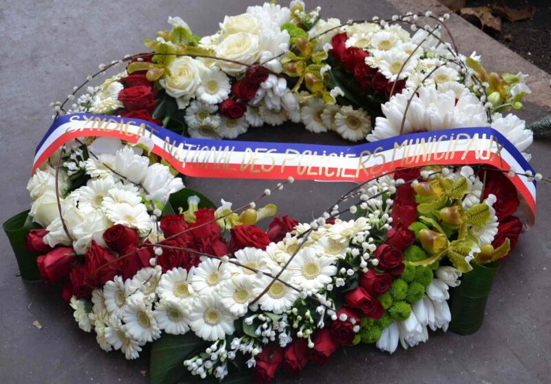 a wreath of flowers on a concrete surface