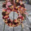 a wreath of flowers on a sidewalk