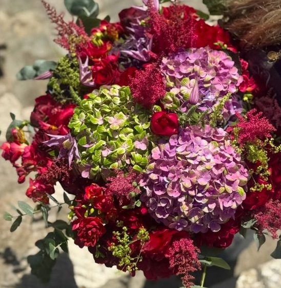 Bouquet with pink hydrangea and rich burgundy flowers.