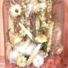 a glass dome with dried flowers