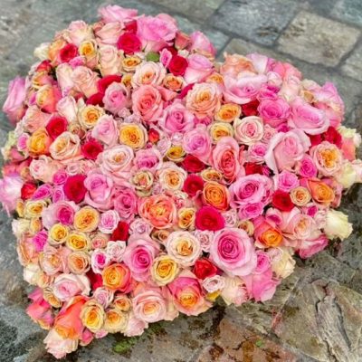 Heart-shaped floral piece with pink roses.