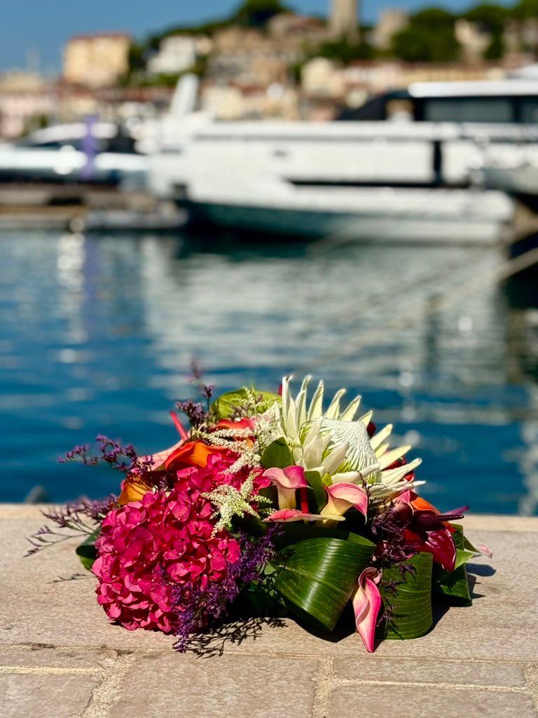 Tropical floral arrangement by the water.