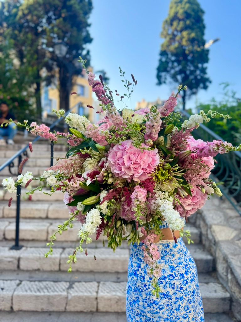 Romantic pink arrangement in a blue patterned vase.