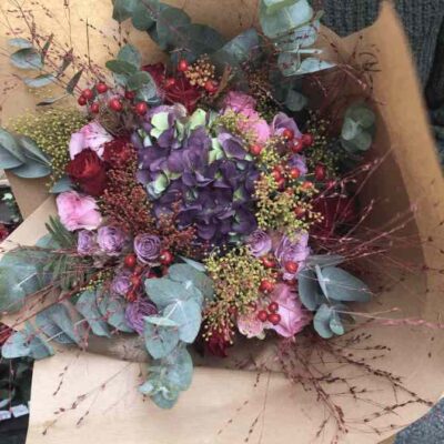 a bouquet of flowers in a brown paper